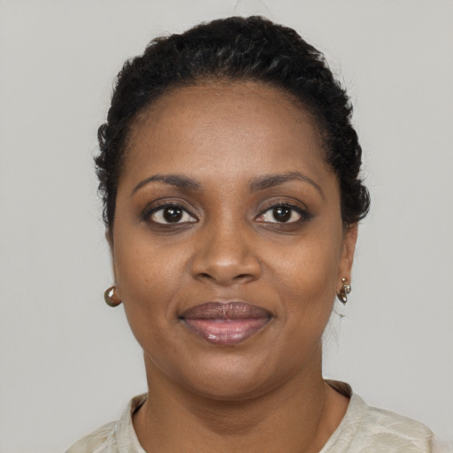 Joyful black young-adult female with short  brown hair and brown eyes