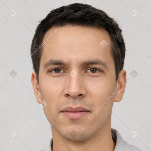 Joyful white young-adult male with short  black hair and brown eyes