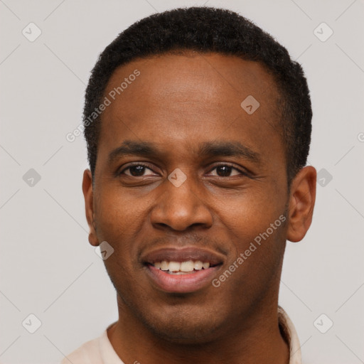 Joyful black young-adult male with short  black hair and brown eyes