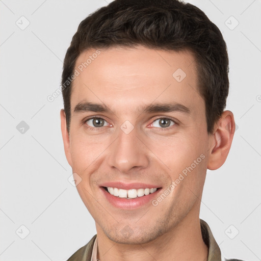 Joyful white young-adult male with short  brown hair and brown eyes