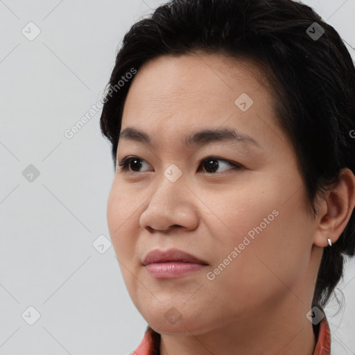 Joyful asian young-adult female with medium  black hair and brown eyes