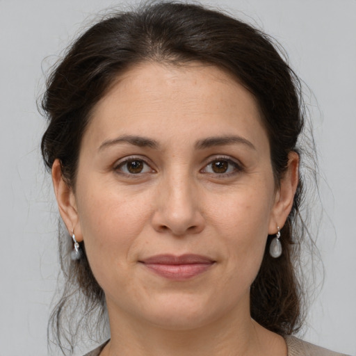 Joyful white adult female with medium  brown hair and brown eyes