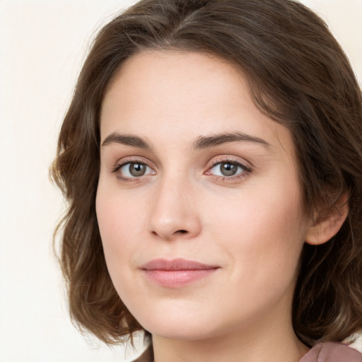 Joyful white young-adult female with long  brown hair and green eyes