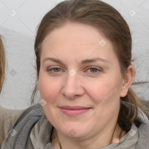 Joyful white adult female with medium  brown hair and grey eyes