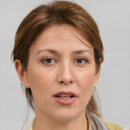 Joyful white adult female with medium  brown hair and grey eyes