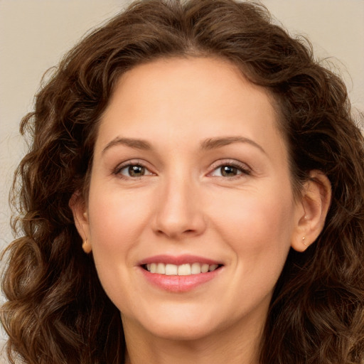 Joyful white young-adult female with long  brown hair and green eyes