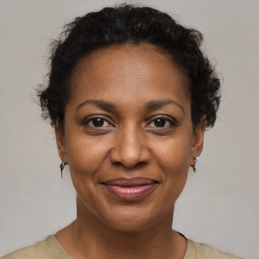 Joyful black adult female with short  brown hair and brown eyes