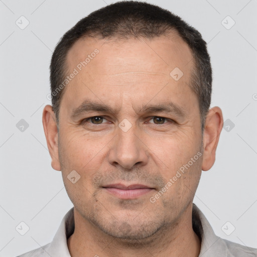 Joyful white adult male with short  brown hair and brown eyes