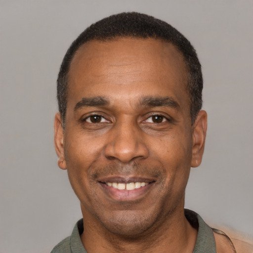 Joyful latino adult male with short  black hair and brown eyes