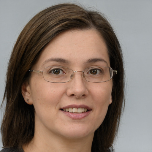 Joyful white adult female with medium  brown hair and grey eyes