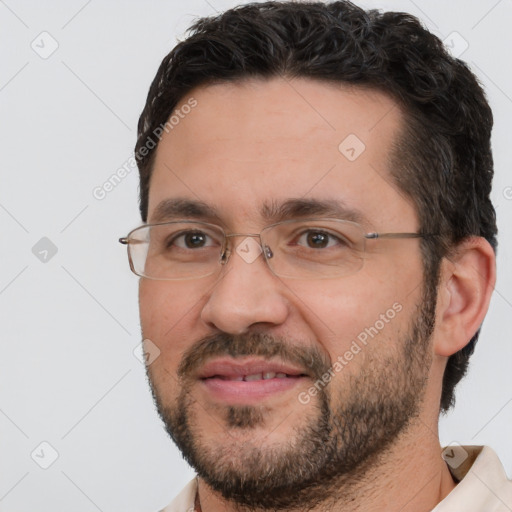 Joyful white adult male with short  black hair and brown eyes