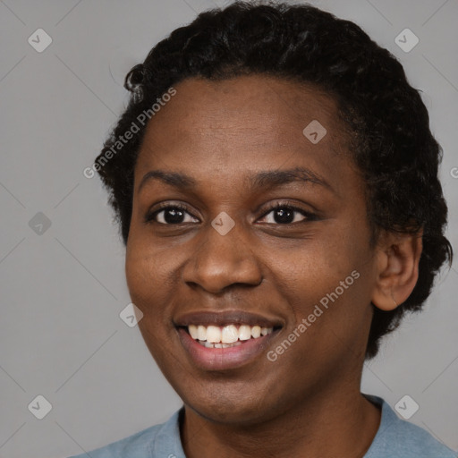 Joyful black young-adult female with short  black hair and brown eyes