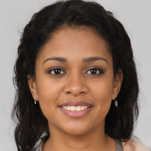 Joyful black young-adult female with medium  brown hair and brown eyes