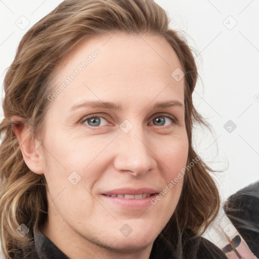 Joyful white young-adult female with long  brown hair and blue eyes