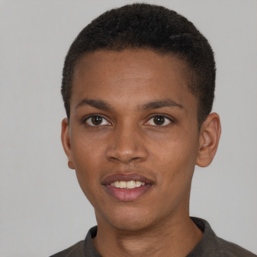 Joyful black young-adult male with short  brown hair and brown eyes