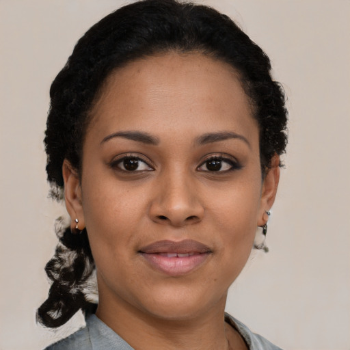 Joyful black young-adult female with short  black hair and brown eyes