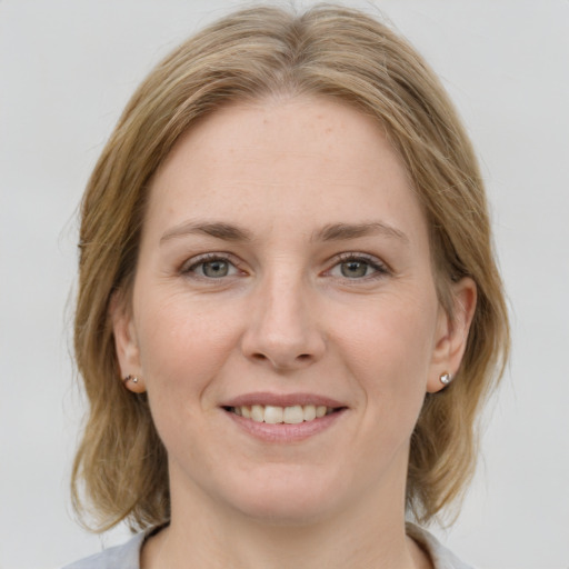 Joyful white young-adult female with medium  brown hair and blue eyes