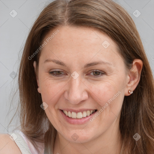 Joyful white adult female with long  brown hair and grey eyes