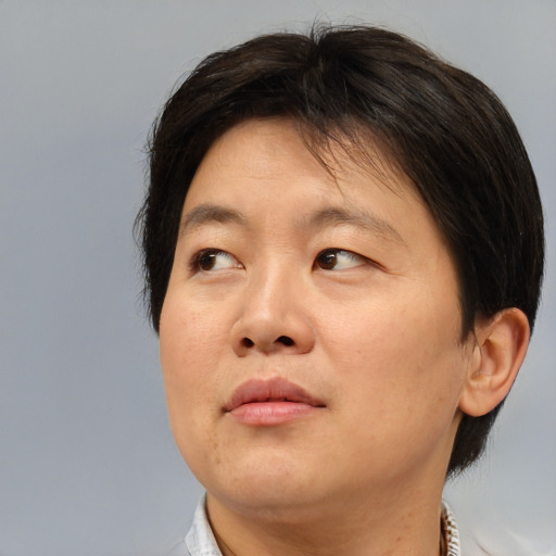 Neutral asian adult female with medium  brown hair and brown eyes