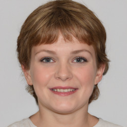 Joyful white young-adult female with medium  brown hair and blue eyes