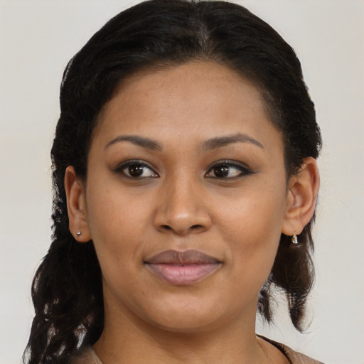 Joyful black young-adult female with medium  brown hair and brown eyes
