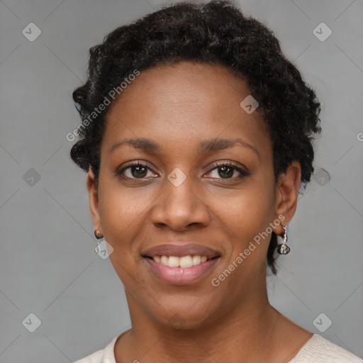 Joyful black young-adult female with short  black hair and brown eyes