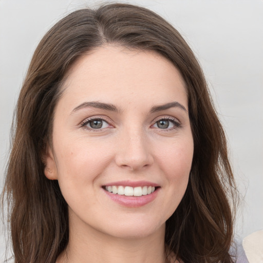 Joyful white young-adult female with long  brown hair and grey eyes