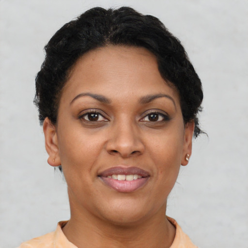 Joyful latino adult female with short  brown hair and brown eyes