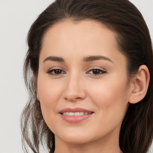 Joyful white young-adult female with long  brown hair and brown eyes