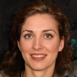 Joyful white young-adult female with medium  brown hair and green eyes