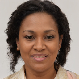 Joyful black adult female with medium  brown hair and brown eyes