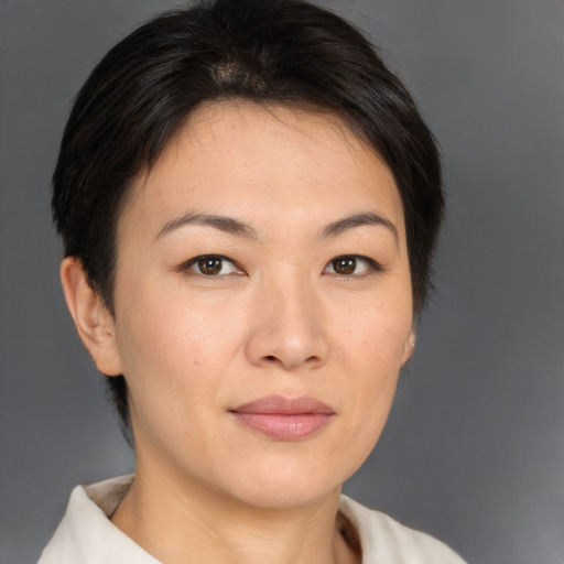 Joyful asian young-adult female with short  brown hair and brown eyes