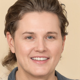 Joyful white adult female with medium  brown hair and grey eyes