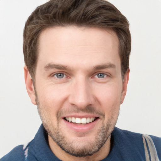 Joyful white young-adult male with short  brown hair and grey eyes