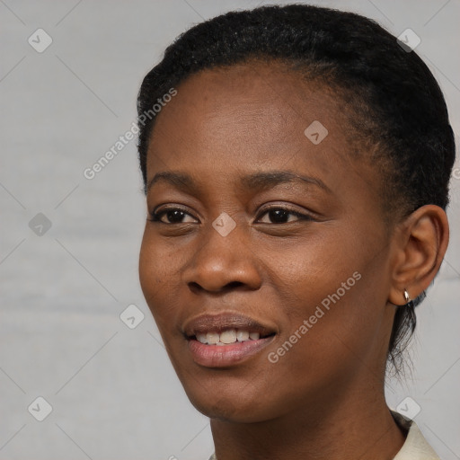 Joyful black young-adult female with short  black hair and brown eyes