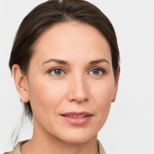 Joyful white young-adult female with medium  brown hair and grey eyes