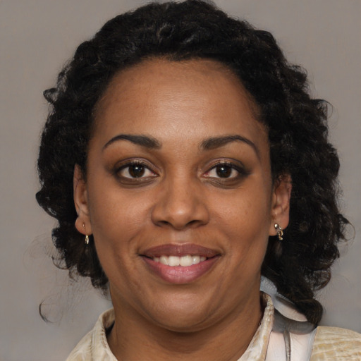 Joyful black young-adult female with medium  brown hair and brown eyes