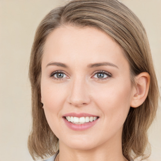 Joyful white young-adult female with medium  brown hair and green eyes