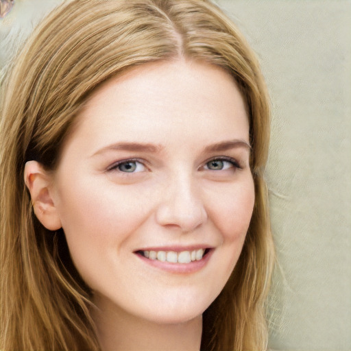 Joyful white young-adult female with long  brown hair and blue eyes