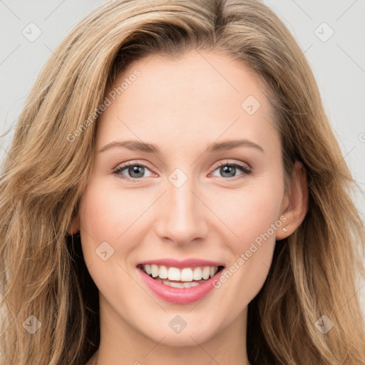 Joyful white young-adult female with long  brown hair and green eyes