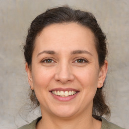 Joyful white adult female with medium  brown hair and brown eyes