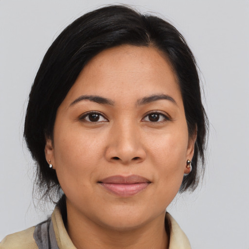 Joyful asian young-adult female with medium  brown hair and brown eyes