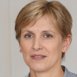 Joyful white adult female with medium  brown hair and grey eyes