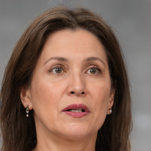 Joyful white adult female with long  brown hair and grey eyes