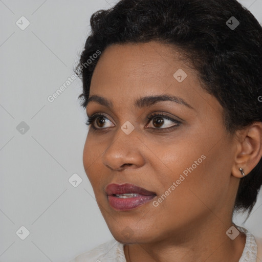 Joyful black young-adult female with short  brown hair and brown eyes