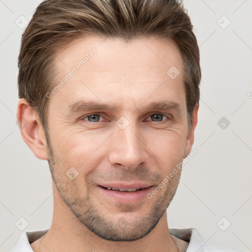 Joyful white adult male with short  brown hair and grey eyes