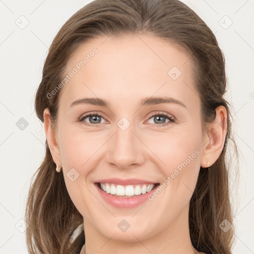 Joyful white young-adult female with long  brown hair and grey eyes