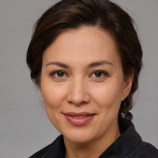 Joyful white adult female with medium  brown hair and brown eyes