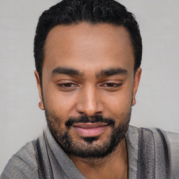 Joyful black young-adult male with short  black hair and brown eyes