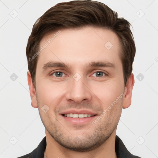 Joyful white young-adult male with short  brown hair and grey eyes